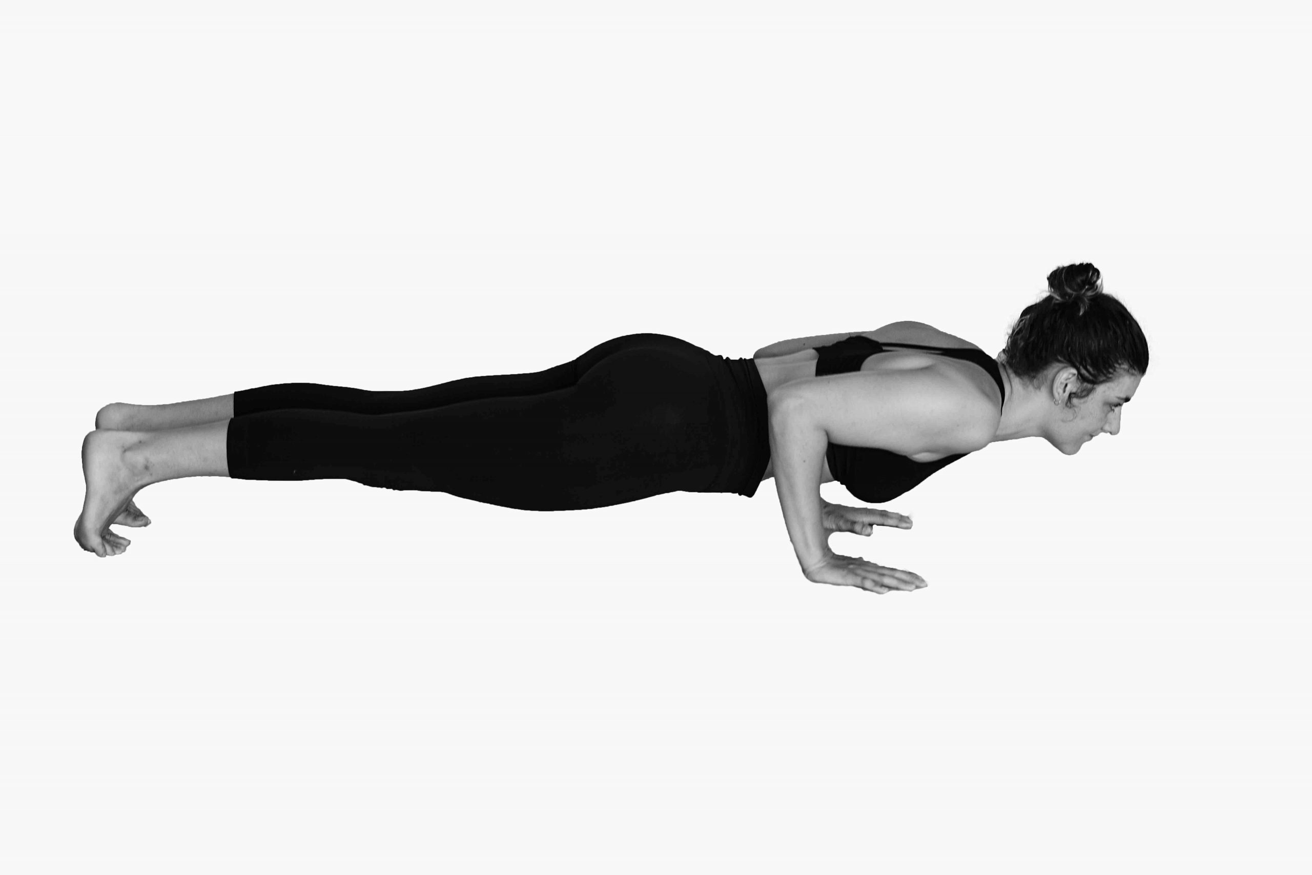 Chaturanga Dandasana pose, often found in both Ashtanga Yoga and Vinyasa Yoga