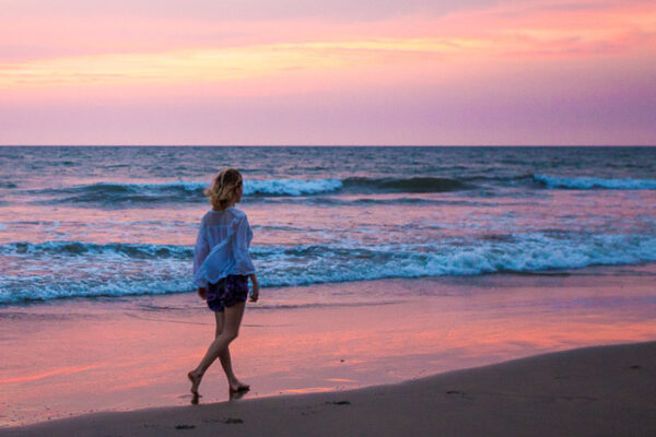 Girl walking on the beach in Goa, India