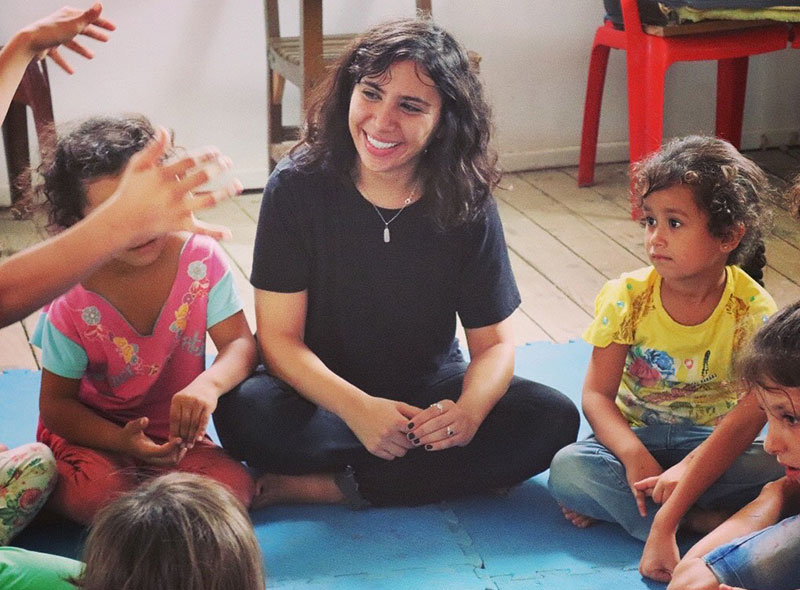 Sandy Boutros smiling with kids