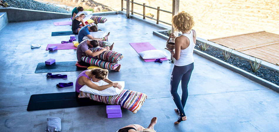 Joanna Vladescu with singing bowl in open-air yoga studio