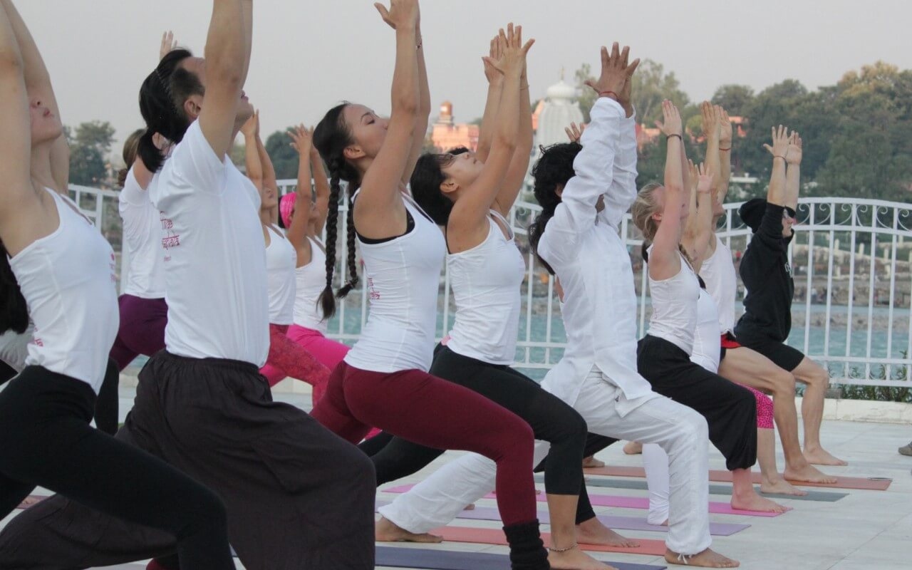 Students in Warrior one pose