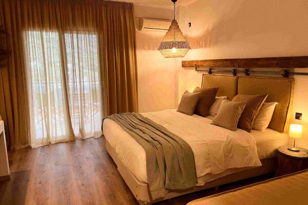 236CA053-E5B6-4EF6-933A-08D475653BFB (1)_11zon A bedroom with brown curtains and 4 pillows