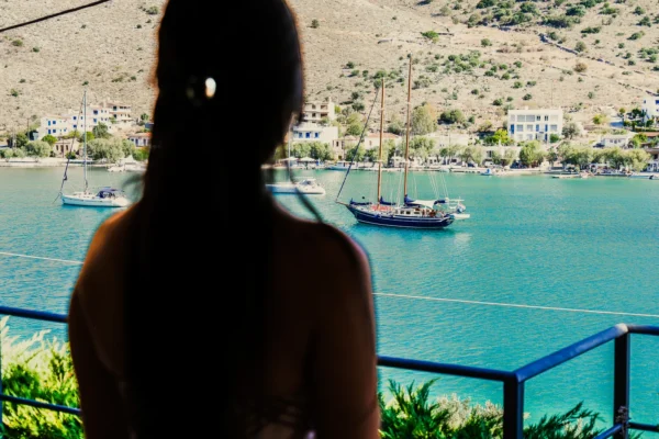 P1000271-HDR (1) Yoga student looking out at the sea on Evia Island, Greece. She is finishing a yoga teacher training, and stares at the sailboats and turquoise water.