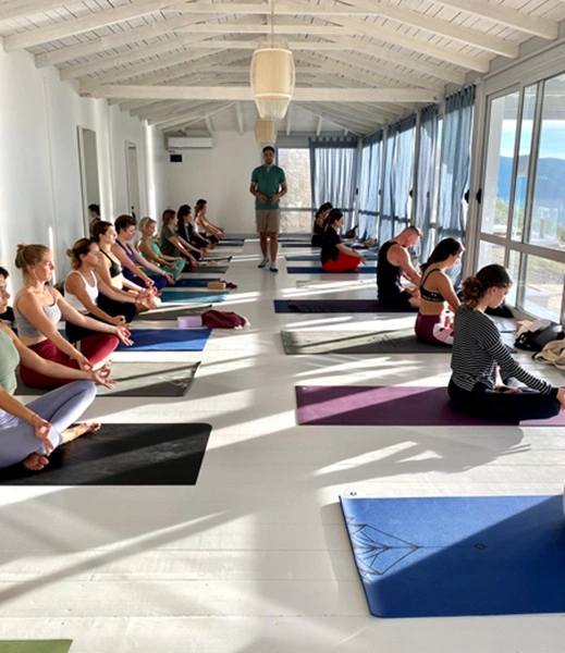 Teacher teaching yoga in 200hr YTT in Greeece